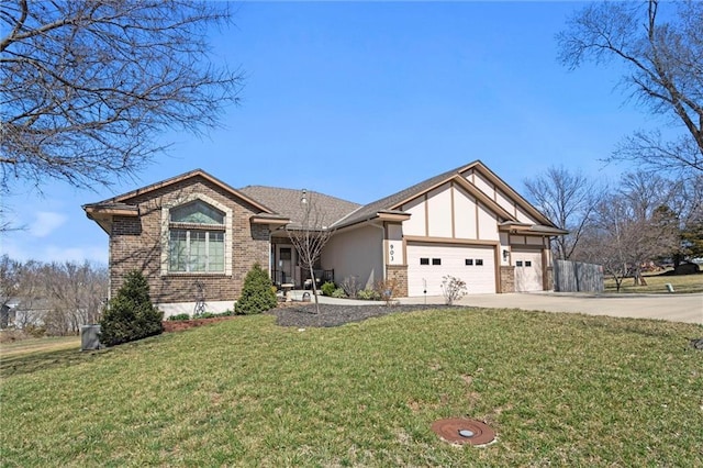 view of front of property featuring a garage, a front yard, and driveway