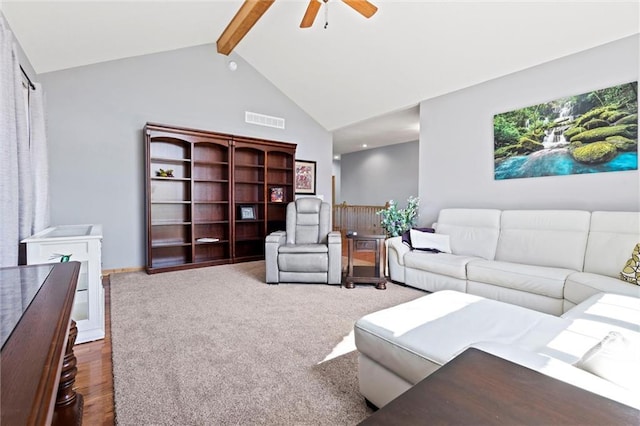 living area with wood finished floors, a ceiling fan, visible vents, high vaulted ceiling, and beamed ceiling