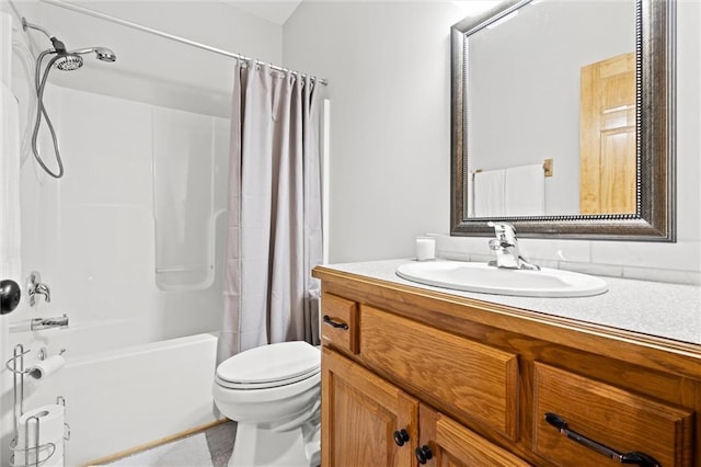 full bath featuring shower / bath combo with shower curtain, toilet, and vanity