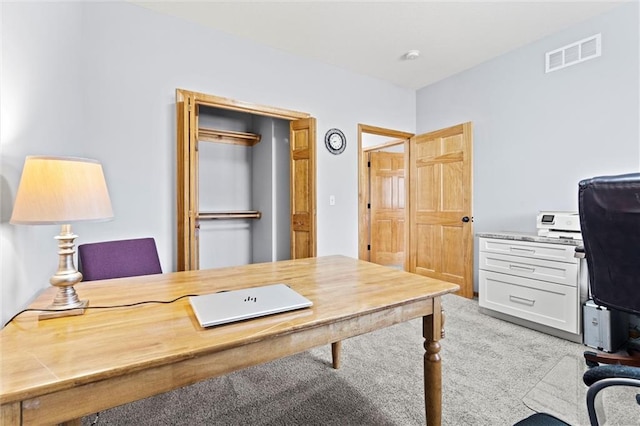 home office featuring visible vents and light carpet