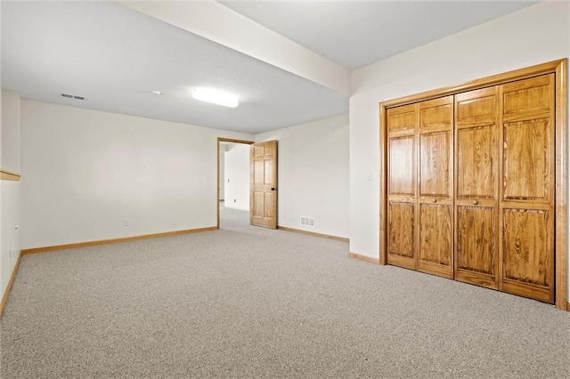 unfurnished bedroom with visible vents, baseboards, and carpet floors