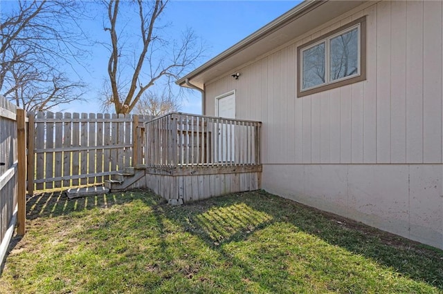 view of yard with a deck and fence