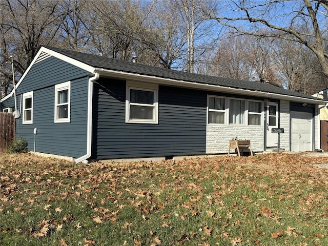 exterior space with a garage and a front lawn