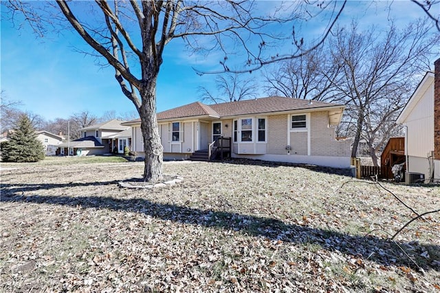 view of front of home with brick siding and cooling unit