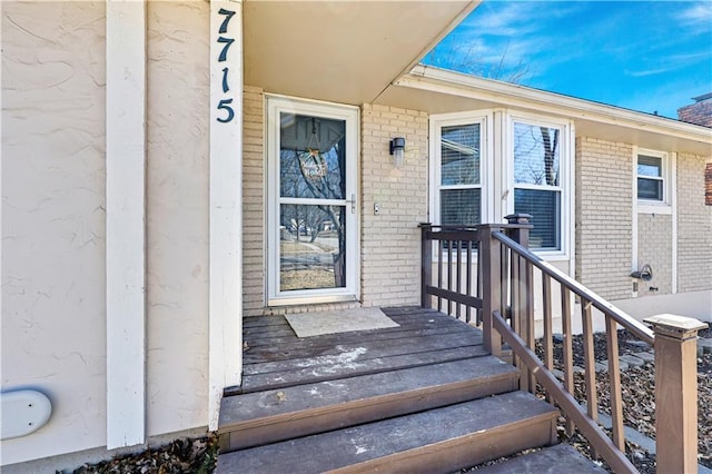 entrance to property featuring brick siding