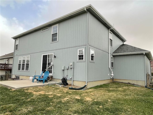 back of house featuring a patio and a yard