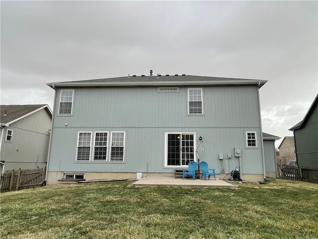 rear view of house featuring a lawn, a patio, and fence