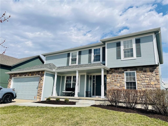 view of front of home with stone siding, an attached garage, and a front lawn