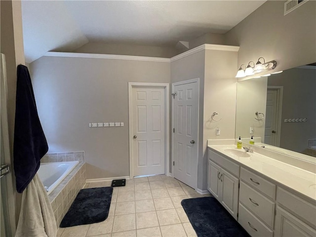 bathroom with visible vents, tiled tub, vaulted ceiling, tile patterned floors, and vanity