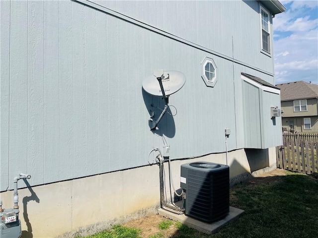 exterior details with central AC unit and fence