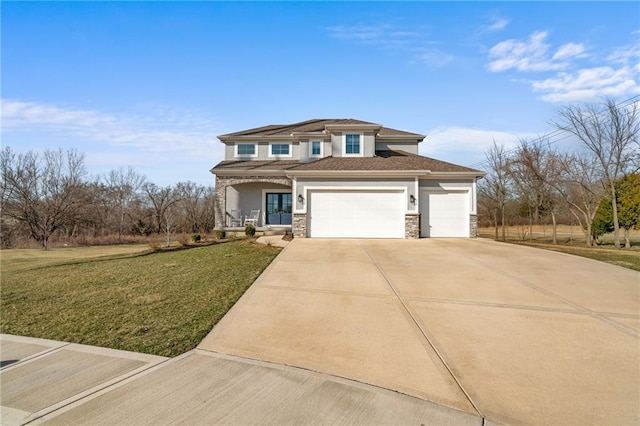 prairie-style home featuring stucco siding, driveway, stone siding, a front yard, and a garage