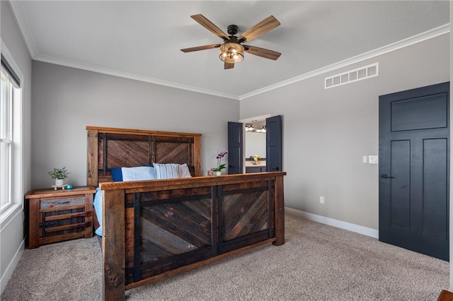 carpeted bedroom featuring visible vents, baseboards, ceiling fan, and crown molding