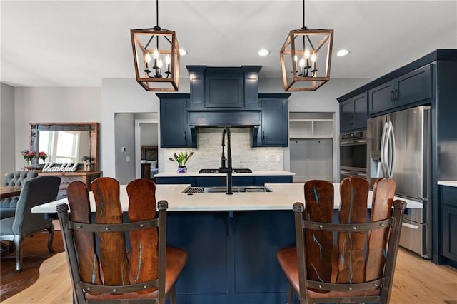 kitchen featuring light wood-type flooring, tasteful backsplash, stainless steel fridge with ice dispenser, and light countertops