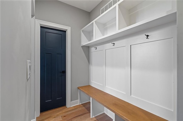 mudroom with visible vents, light wood-type flooring, and baseboards