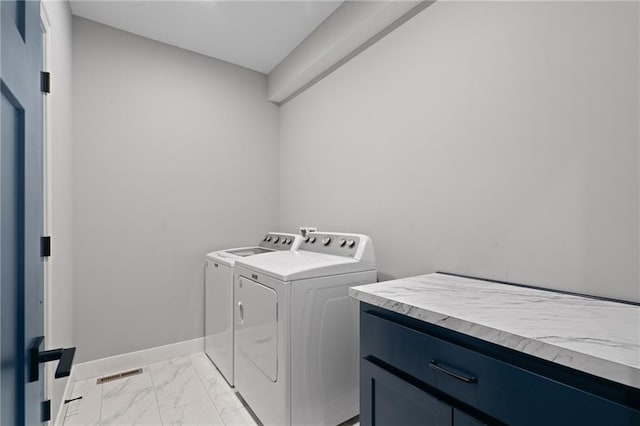 laundry room featuring visible vents, baseboards, cabinet space, washer and dryer, and marble finish floor