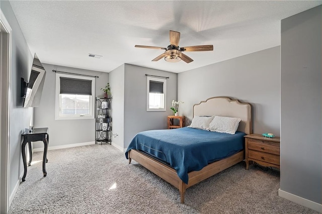 carpeted bedroom with multiple windows, visible vents, and baseboards