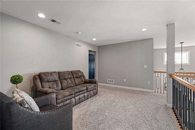 carpeted living room featuring recessed lighting, visible vents, and baseboards