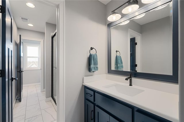 bathroom featuring visible vents, marble finish floor, a stall shower, and vanity