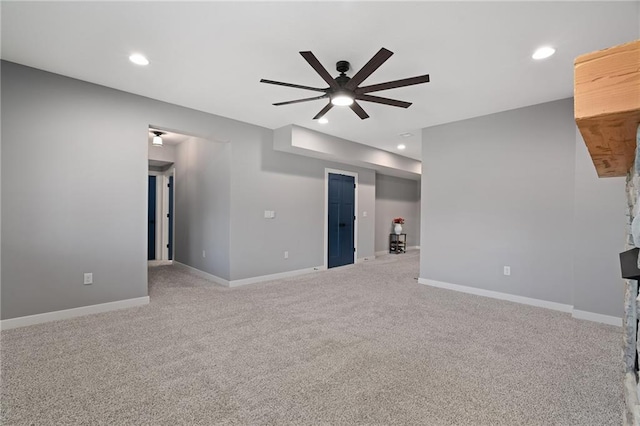 unfurnished living room featuring a ceiling fan, recessed lighting, baseboards, and light carpet