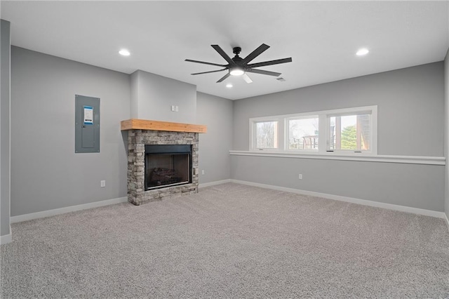 unfurnished living room featuring electric panel, baseboards, recessed lighting, and a fireplace