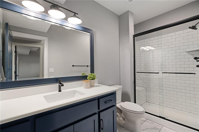 bathroom featuring vanity, toilet, marble finish floor, and a stall shower