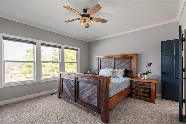 bedroom with baseboards, light colored carpet, ornamental molding, and a ceiling fan