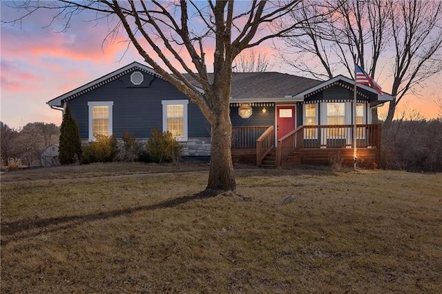 ranch-style house featuring a porch and a front yard