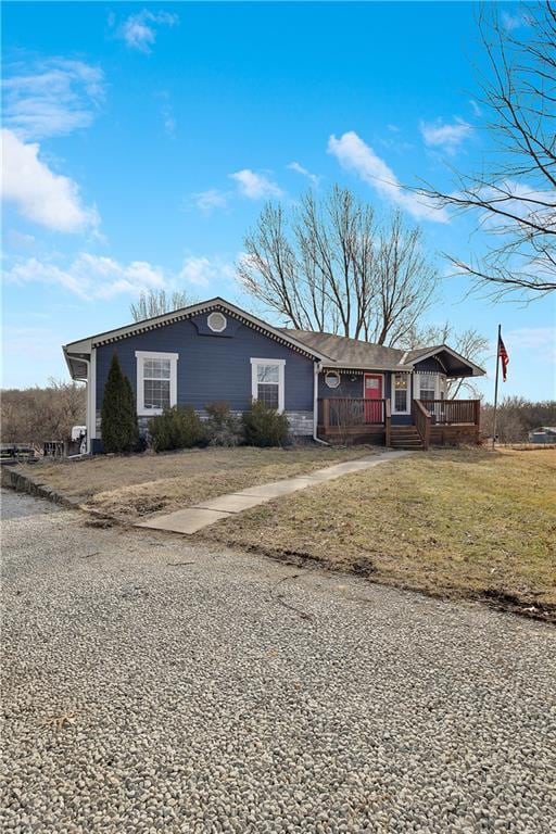 single story home with covered porch and a front lawn