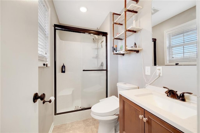 full bath with visible vents, a stall shower, vanity, and toilet