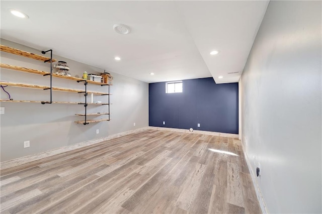 basement with baseboards, wood finished floors, and recessed lighting