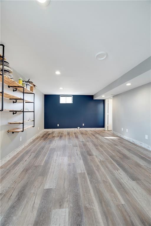 interior space featuring baseboards, wood finished floors, and recessed lighting