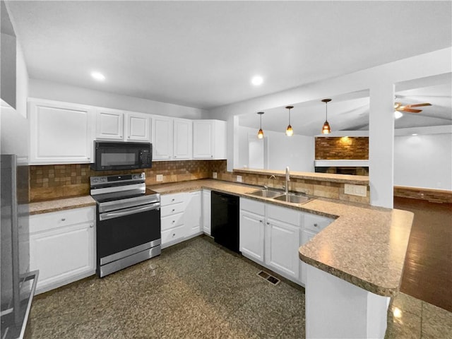 kitchen featuring black appliances, a peninsula, a sink, and decorative backsplash