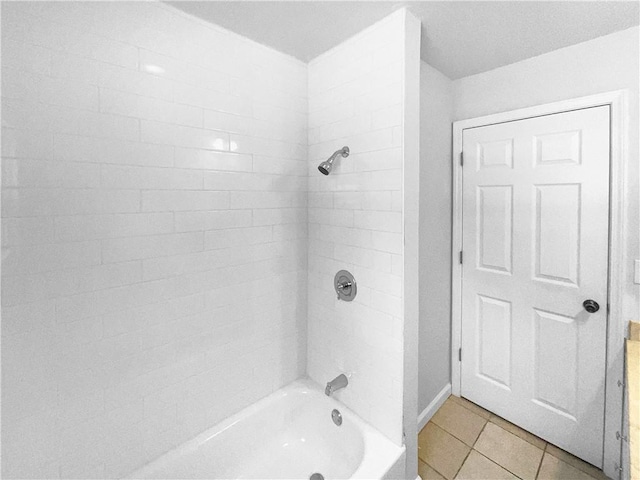 bathroom with tile patterned flooring and bathtub / shower combination