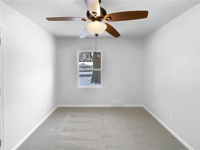 empty room featuring carpet flooring, visible vents, and baseboards