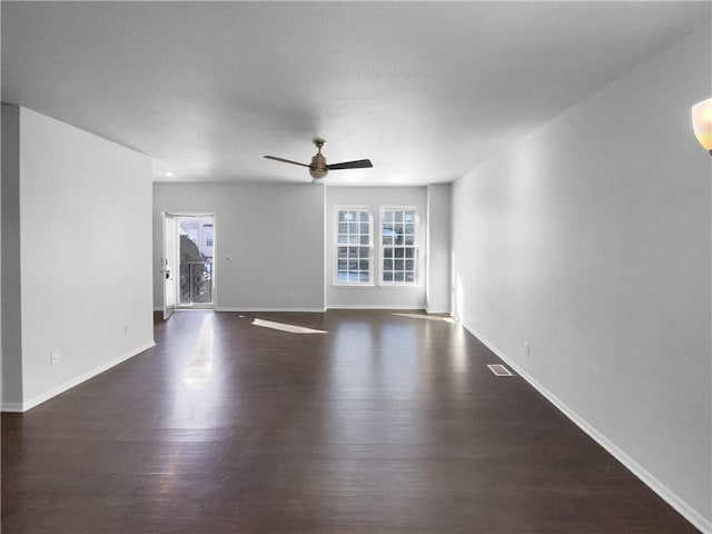 unfurnished living room with a healthy amount of sunlight, ceiling fan, baseboards, and wood finished floors