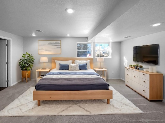 carpeted bedroom featuring recessed lighting, visible vents, a textured ceiling, and baseboards