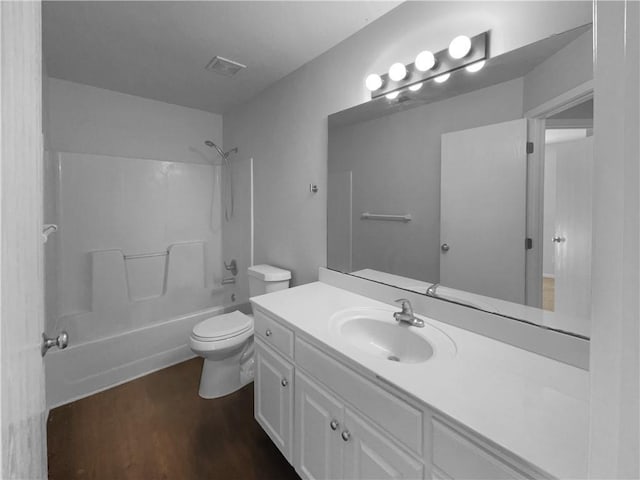 bathroom featuring shower / bathtub combination, toilet, wood finished floors, vanity, and visible vents