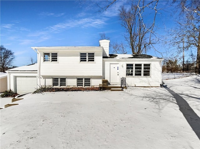 view of front of home with an attached garage and a chimney