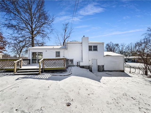 rear view of property with a deck and a chimney