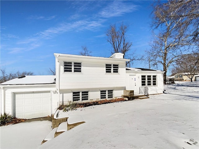 view of front of property featuring a garage and a chimney