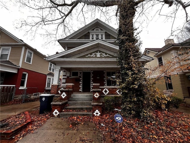 view of front of home with covered porch and brick siding