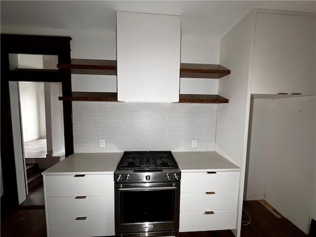 kitchen with stainless steel gas range oven, white cabinets, decorative backsplash, open shelves, and modern cabinets