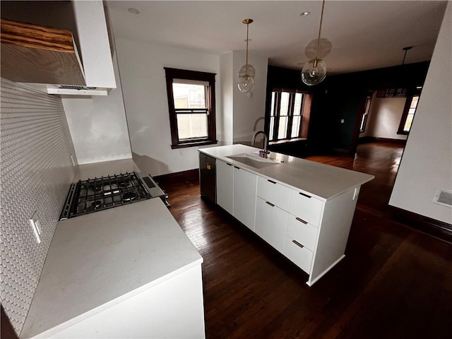 kitchen featuring a sink, white cabinets, wall chimney range hood, dark wood-style floors, and modern cabinets