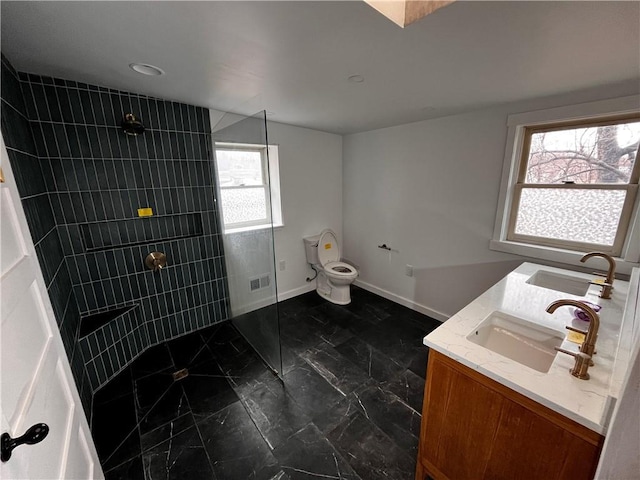 bathroom with marble finish floor, walk in shower, a sink, and visible vents