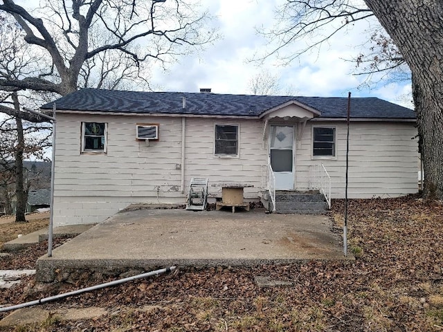 rear view of property with entry steps and a patio