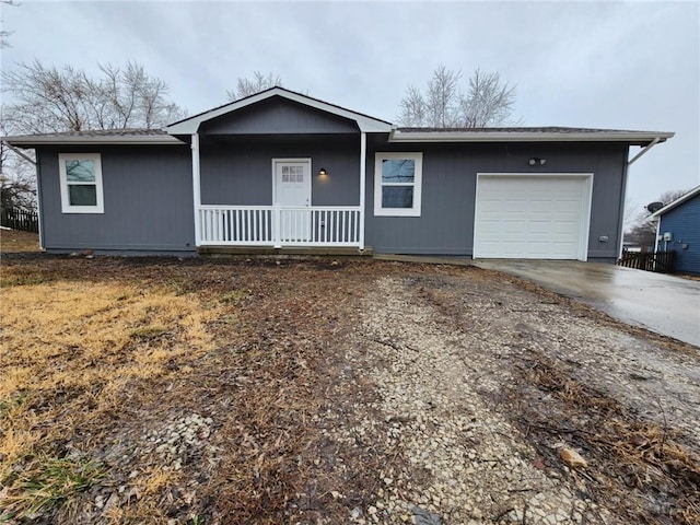 ranch-style house featuring driveway, a porch, and an attached garage