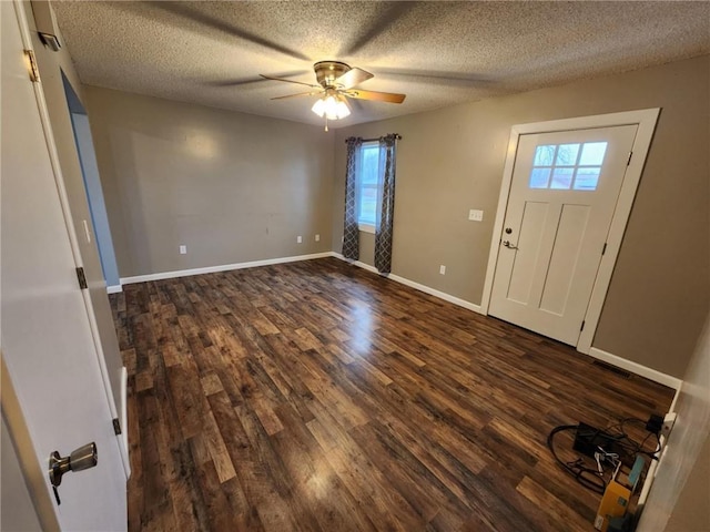 foyer featuring dark wood-type flooring, ceiling fan, a textured ceiling, and baseboards