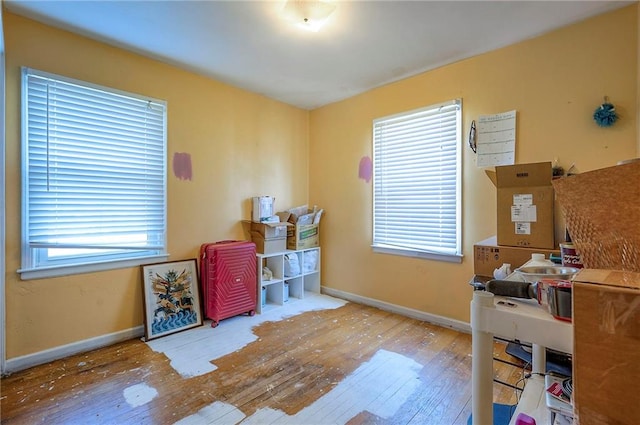 office featuring hardwood / wood-style flooring, plenty of natural light, and baseboards