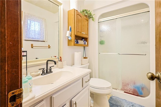 full bathroom featuring a shower stall, vanity, and toilet