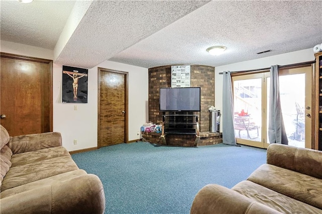 living area with baseboards, visible vents, carpet floors, a textured ceiling, and a brick fireplace